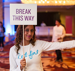 woman holding 'break this way' sign in facebook brand activation