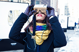 woman looking through virtual reality glasses