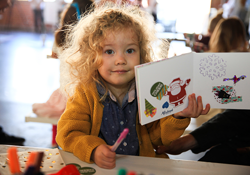 little girl with holiday coloring book