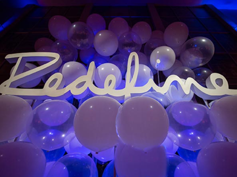 redefine sign covered in balloons